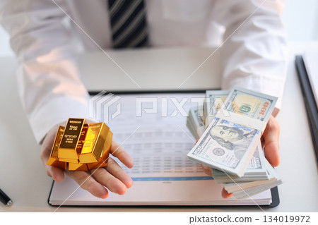 Businessman investing in gold to save assets against inflation and currency depreciation. Businessman investing in gold to save assets against inflation and currency depreciation. 134019972