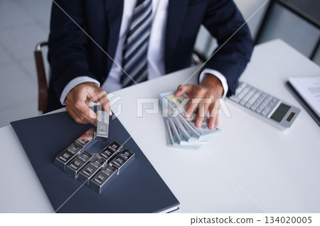 Silver Trading Businessman invest in trading silver, calculating profit price of buying and selling silver in the market. 134020005