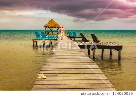 Wooden pier and Caribbean Sea view at Caye Caulker Belize Caribbean. Wooden pier and Caribbean Sea view at Caye Caulker Belize Caribbean. 134020059