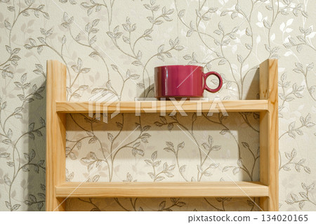 purple tea mug on wooden shelf purple tea mug on wooden shelf 134020165