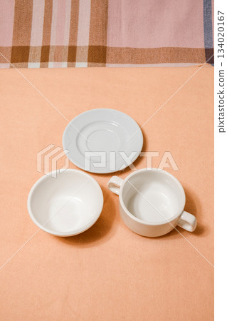 white empty dishes bowls and saucers on table 134020167