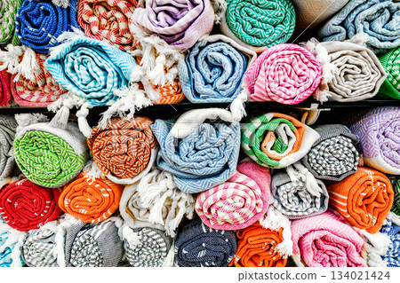 colorful rolled-up mats are sold on the counter in the store colorful rolled-up mats are sold on the counter in the store 134021424