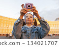 Portrait girl tourist takes photo of landmark in center of St. Petersburg 134021707
