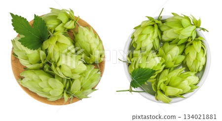 Hop cones in wooden and ceramic bowl isolated on white background. Beer brewing ingredients. Top view. Flat lay Hop cones in wooden and ceramic bowl isolated on white background. Beer brewing ingredients. Top view. Flat lay 134021881
