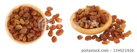 Brown raisins in wooden bowl isolated on white background . Top view. Flat lay 134021926