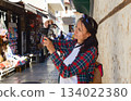A young female tourist takes photographs of souvenirs at the tourist market in old Antalya, Turkey. 134022380