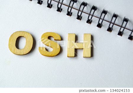 OSH representing Occupational Health and Safety on white notepad. OSH representing Occupational Health and Safety on white notepad. 134024153