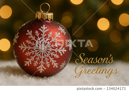 Seasons greetings, Close up red glittered Christmas bauble surrounded by cozy warm lights offering an elegant festive decorative mood. Seasons greetings, Close up red glittered Christmas bauble surrounded by cozy warm lights offering an elegant festive decorative mood. 134024171