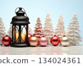 Lantern with Christmas trees and snow covered scenery capturing the warmth of festive winter nights. With customizable space for text. 134024361