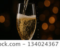 Champagne celebration scene with festive golden lights arranged for a luxurious holiday toast with customizable space for text. 134024367