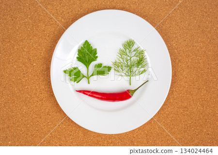 Fresh red hot peppers on a white plate. Vitamin wholesome food. 134024464