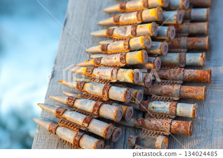 old rusty cartridges in a machine-gun belt. war in Ukraine. military ammunition 134024485