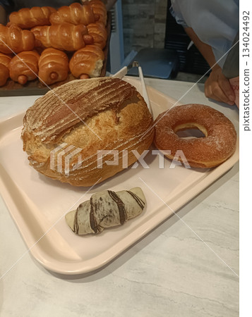Crusty bread sugar doughnut mini croissant bakery tray fresh pastry golden crust soft crumb sweet treat delight 134024492