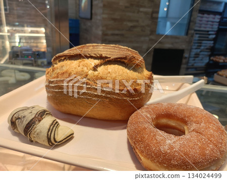 Crusty bread artisan loaf sugared doughnut mini pastry bakery display fresh baked golden crust soft crumb inviting Crusty bread artisan loaf sugared doughnut mini pastry bakery display fresh baked golden crust soft crumb inviting 134024499