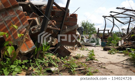 View to destroyed residential buildings at Kharkivska oblast. Ruined houses after bomb attacks on ukrainian territory from russia army. Consequences of russian invasion of Ukraine. Slow motion 134024726