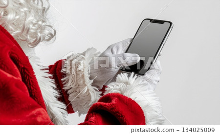 Mockup of a Santa gloved hand operating a smartphone on a white background 134025009