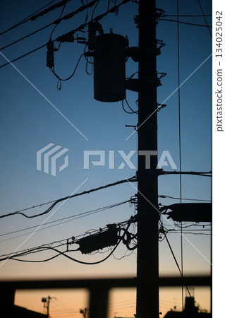 Twilight sky and the shadow of a utility pole Twilight sky and the shadow of a utility pole 134025042