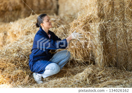 Asian female worker inspect straw in storage Asian female worker inspect straw in storage 134026162
