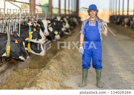 Portrait of male farm employee in blue jumpsuit 134026164