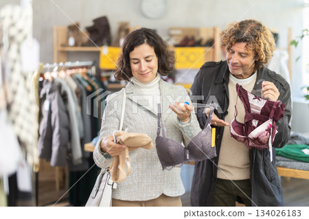 Married couple woman and man search and choose bra 134026183