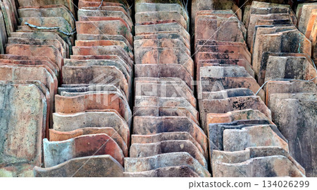 Rustic Texture of Stacked Traditional Flat Terracotta Clay Roof Tiles 134026299