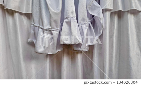 Close-Up Detail of Decorative White Fabric Ruffles and Folds 134026304