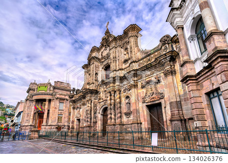 Ornate stone facade of La Compania de Jesus church stands in historic center of Quito, Ecuador. Baroque architecture features intricate carvings and Solomonic columns in UNESCO World Heritage site 134026376