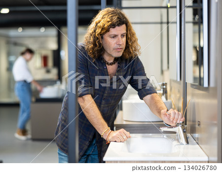 Confident man picking out new bathroom sink in hardware store Confident man picking out new bathroom sink in hardware store 134026780