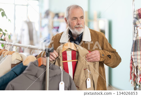 Family clothing store, senior man customer choose raincoat 134026853
