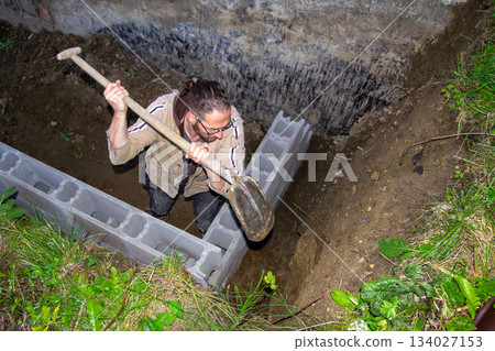 Building a fundamental brick wall in a mountain. 134027153