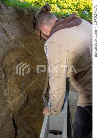 Building a fundamental brick wall in a mountain. 134027175