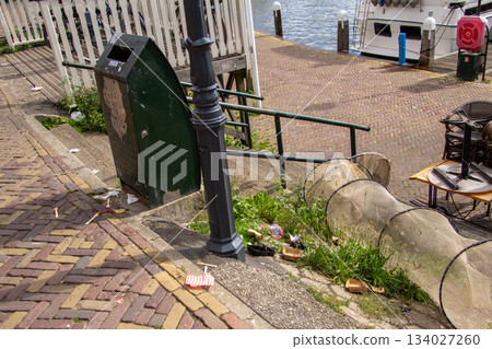 Catching garbage in a garbage bin or in a fishing net. 134027260