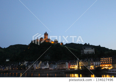 Panoramic view of the boulevard in Cochem in the evening city lights. Panoramic view of the boulevard in Cochem in the evening city lights. 134027496