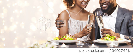 Celebration concept. Cropped of black couple drinking champagne and eating at restaurant, panorama Celebration concept. Cropped of black couple drinking champagne and eating at restaurant, panorama 134027668