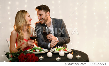 Loving Couple Enjoying Romantic Date In Restaurant, Dining Together, Drinking Wine And Looking At Each Other With Affection. 134027771