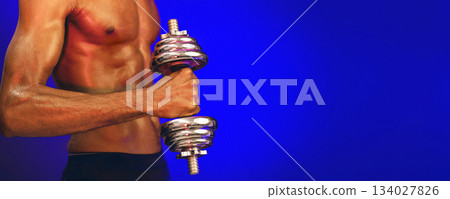Bodybuilding Workout. Unrecognizable Strong Muscular Man Exercising With Dumbbells Over Blue Background In Studio, Focus On Dumbbell. Panorama 134027826