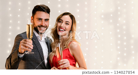 Cheers. Romantic Couple Posing With Champagne Glasses, Greeting With Holidays, Congratulating With Valentine's Day, Empty Space 134027854