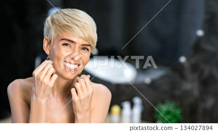 Tooth Care Routine. Cheerful Woman Flossing Her Teeth Standing In Bathroom At Home. Empty Space For Text Tooth Care Routine. Cheerful Woman Flossing Her Teeth Standing In Bathroom At Home. Empty Space For Text 134027894