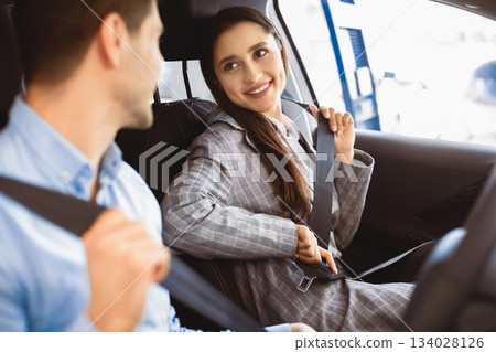 Car Safety. Young couple fastening seat belts in their brand-new auto 134028126