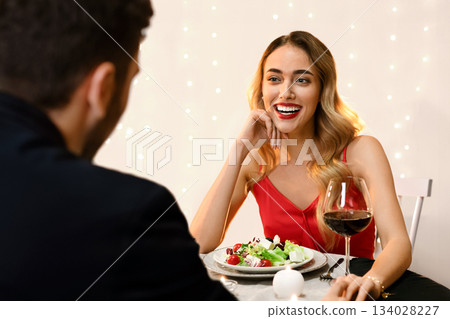 Pleasant Evening. Couple Enjoying Romantic Date In Restaurant, Celebrating Valentine's Day Or Anniversary Together, Selective Focus Pleasant Evening. Couple Enjoying Romantic Date In Restaurant, Celebrating Valentine's Day Or Anniversary Together, Selective Focus 134028227