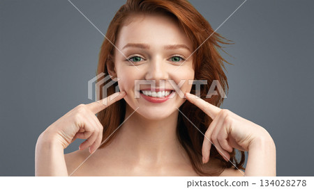 Smile. Beautiful Cheerful Red-Haired Young Lady Touching Dimples In Her Cheeks Smiling To Camera Posing Shirtless Over White Studio Background. Positive Emotions, Female Beauty Portrait Concept Smile. Beautiful Cheerful Red-Haired Young Lady Touching Dimples In Her Cheeks Smiling To Camera Posing Shirtless Over White Studio Background. Positive Emotions, Female Beauty Portrait Concept 134028278