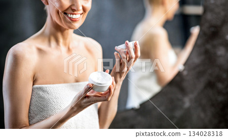 Skincare And Beauty. Smiling Woman Opening New Facial Cream Standing In Bathroom At Home. Free Space 134028318