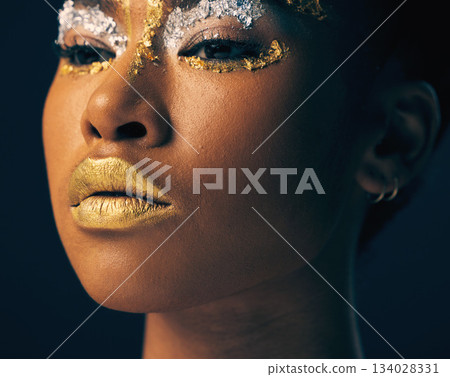 Beauty, gold and face with black woman and makeup in studio for luxury, cosmetics and African pride. Natural, creative and goddess with female model on background for queen, bronze and glamour Beauty, gold and face with black woman and makeup in studio for luxury, cosmetics and African pride. Natural, creative and goddess with female model on background for queen, bronze and glamour 134028331