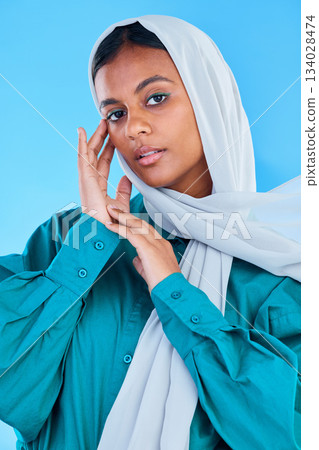 Muslim, woman and serious portrait in studio, blue background and color backdrop. Young female model, islamic culture and beauty of empowerment, proud religion and arabic fashion of elegant hijab Muslim, woman and serious portrait in studio, blue background and color backdrop. Young female model, islamic culture and beauty of empowerment, proud religion and arabic fashion of elegant hijab 134028474