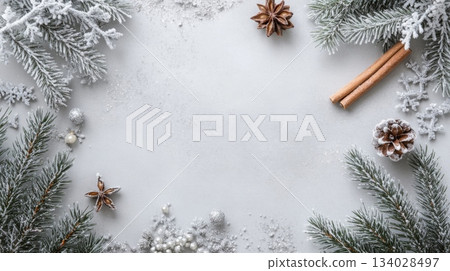 An arrangement of frosted evergreen branches, cinnamon sticks, and decorative elements creates a cozy winter atmosphere, perfect for holiday gatherings and seasonal celebrations during wintertime. An arrangement of frosted evergreen branches, cinnamon sticks, and decorative elements creates a cozy winter atmosphere, perfect for holiday gatherings and seasonal celebrations during wintertime. 134028497