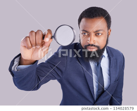 Business black man, magnifying glass and studio with focus for quality inspection, compliance and stop fraud. Businessman, inspector and auditor at company with attention for financial health at job 134028579