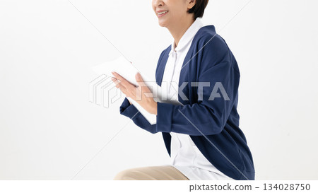 A woman in a white coat conducting a medical interview A woman in a white coat conducting a medical interview 134028750