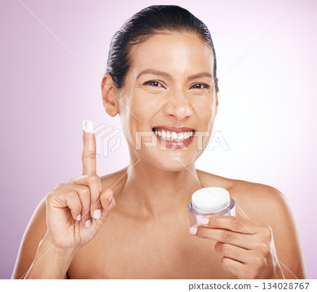 Face, cream jar and skincare of woman in studio isolated on purple background. Mature portrait, cosmetics and happy female model with dermatology lotion, creme or moisturizer product for anti aging. Face, cream jar and skincare of woman in studio isolated on purple background. Mature portrait, cosmetics and happy female model with dermatology lotion, creme or moisturizer product for anti aging. 134028767