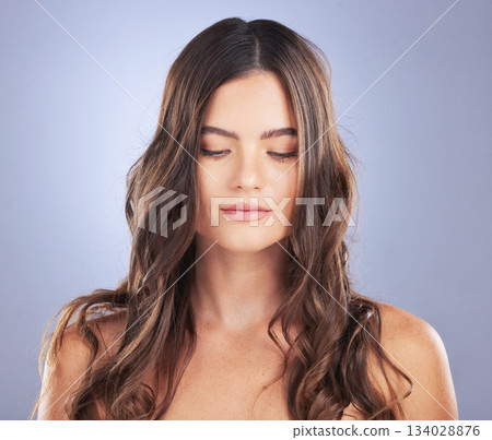 Woman, beauty and hair care in studio for curls, growth and healthy shine on blue background. Aesthetic female model face for haircare, self love and cosmetics for salon or hairdresser results Woman, beauty and hair care in studio for curls, growth and healthy shine on blue background. Aesthetic female model face for haircare, self love and cosmetics for salon or hairdresser results 134028876