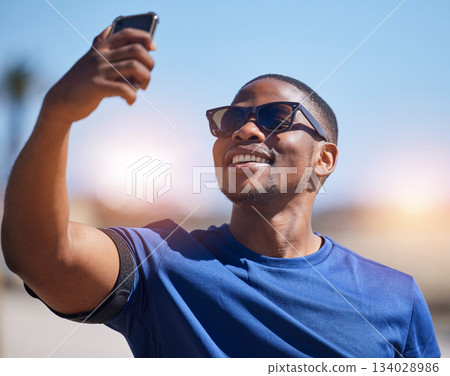 Fitness, selfie and black man runner with phone outdoor for training, running or exercise on blurred background. Happy, guy and social media health influencer smile for photo, profile picture or blog 134028986